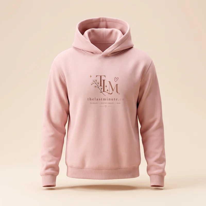 A blush pink hoodie with The Last Minute logo printed on the chest