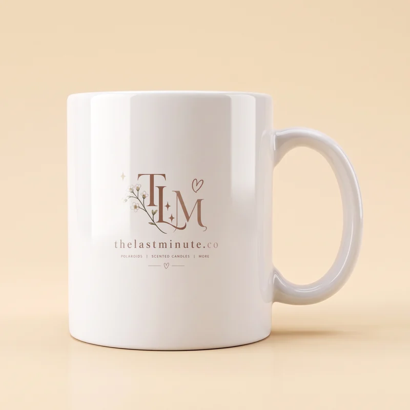 A white mug printed with The Last Minute logo